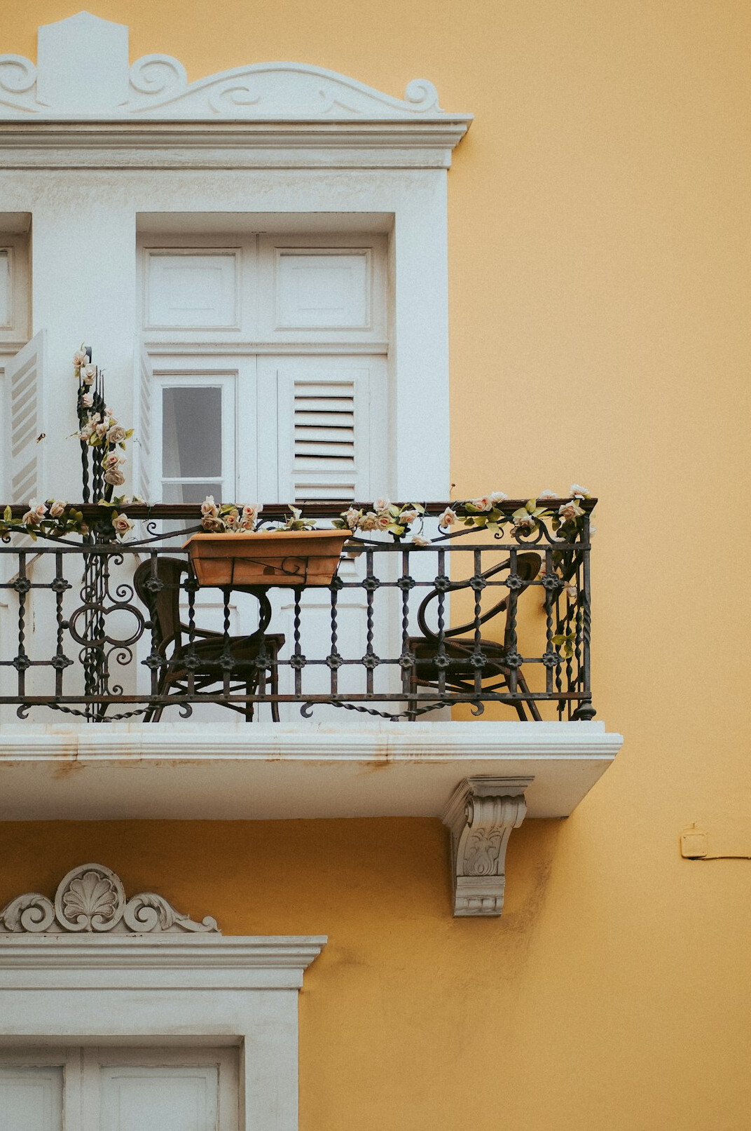 Balcony with potted plants and a small chair